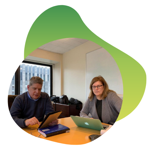 Two S.I.E. members working at a conference table